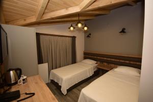 A bed or beds in a room at KORU BUTİK OTEL