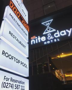 a group of signs on the side of a building at All Nite & Day Hotel Yogjakarta - Gejayan in Yogyakarta