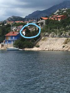 a blue circle in the air over a body of water at Apartman Nina in Karlobag