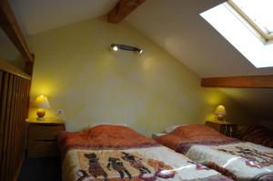 a attic bedroom with two beds and a skylight at cellier 6 in Les Deux Alpes