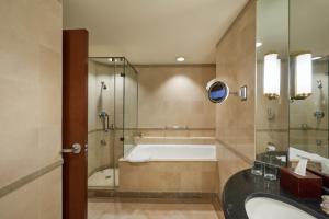 a bathroom with a sink, toilet and bathtub at Grand Nile Tower in Cairo