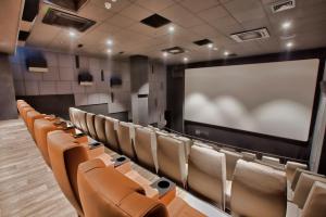 a lecture room with chairs and a projection screen at The Embassy Valletta Hotel in Valletta