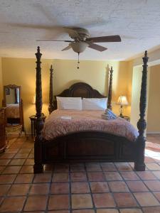 a bedroom with a bed with a ceiling fan at La Maison Hotel - Adults Only in Palm Springs