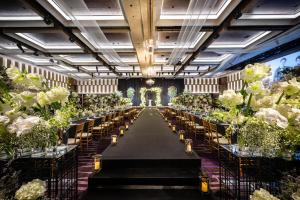 a banquet hall with tables and chairs and flowers at Grand Walkerhill Seoul in Seoul