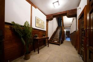 a hallway with wooden walls and stairs with a potted plant at Apartamentos Huertas in Madrid