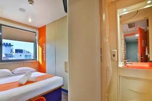 a small room with a bed and a bathroom at easyHotel Sofia in Sofia