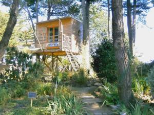 a tree house in the middle of some trees at Manoir de l'Espérance in Corsept