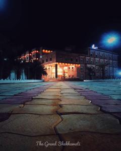 a building at night with a cobblestone street at The Grand Shekhawati in Rāmsir
