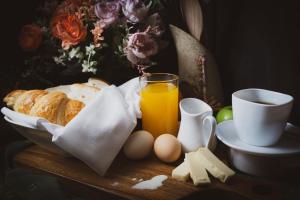 a table with eggs bread and a cup of orange juice at Alicia Apartelle in Cebu City