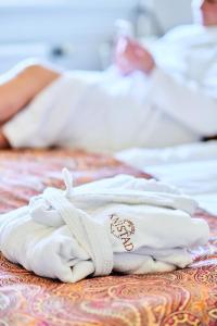 a pile of towels sitting on a bed at Knistad Herrgård in Skövde