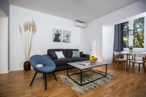 a living room with a couch and a table at Big Tree Apartment & The Nest Apartment - free Parking in Mostar