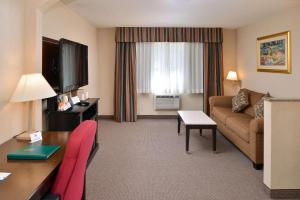 a hotel room with a couch and a table at Quality Inn & Suites Walnut - City of Industry in Walnut