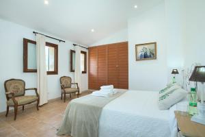 A bed or beds in a room at Owl Booking Villa Siquier - Luxury Retreat with Mountain Views