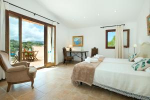 A bed or beds in a room at Owl Booking Villa Siquier - Luxury Retreat with Mountain Views
