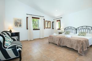 A bed or beds in a room at Owl Booking Villa Siquier - Luxury Retreat with Mountain Views