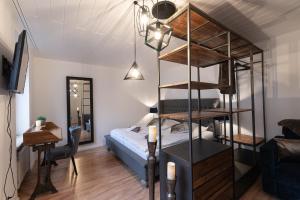 a bedroom with a bunk bed and a living room at Hotel Porta Nigra in Trier