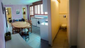 a kitchen and dining room with a table and a laundry room at Au Coeur Des Ecrins in LʼArgentière-la-Bessée +8 photos