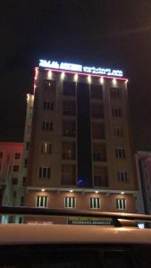 a building with lights on top of it at night at Taj Alarfeen Furnished Building in Salalah