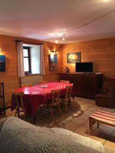 a dining room with a table and a television at gite tourmalet in Barèges