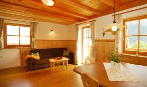 a living room with a couch and a table at Singerhof in Castelrotto