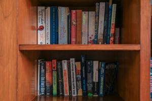 a book shelf filled with lots of books at Alia Home in Sanur