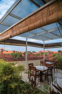 a patio with a table and chairs and a view at Alia Home in Sanur
