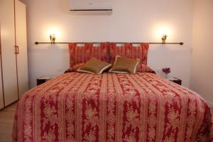 a bedroom with a red bed with two pillows on it at Ca Palazzo in Venice