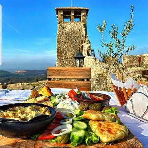 una mesa con un plato de comida en una mesa en ROOMS EMILIANO Castle of Kruja, en Krujë