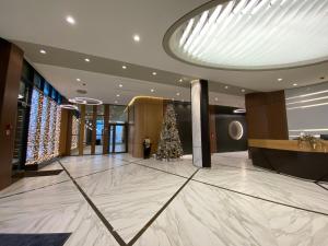 a christmas tree in the lobby of a hotel at Бутик-отель Status in Brest