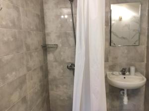 a bathroom with a shower and a sink at Guest House SOTNI in Kyiv