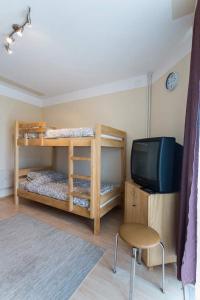 a room with two bunk beds and a television at Hostel Day 'N' Night in Niš