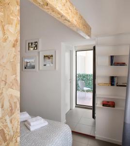 een witte slaapkamer met een bed en een raam bij UP to home - Città Studi in Milaan