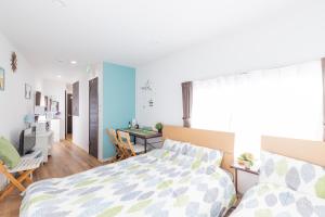 a bedroom with a bed and a living room at Peace Inn Skytree Tokyo in Tokyo