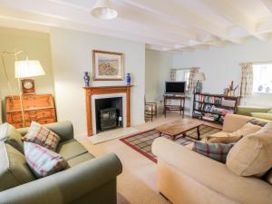 a living room with two couches and a fireplace at Blue Door - Kirkcudbright in Kirkcudbright