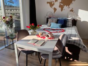 a bedroom with a bed with a table and chairs at BzB Jantina in Heerenveen