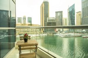 a balcony with a table and a view of a harbor at HiGuests - Cozy Studio with Jaw-Dropping Marina Views in Dubai