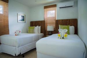 A bed or beds in a room at Bequia Plantation Hotel
