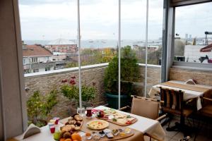 a room with a table with food on it with a window at Blue Mosque Suites 2 - Old City Sultanahmet in Istanbul