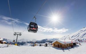 a ski lift in the air over a snow covered mountain at Panorama A in Blatten bei Naters