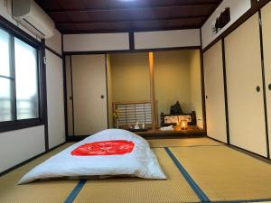 a room with a red pillow on the floor at Private reservation near KIX "Wakeikan" in Hannan +71 photos