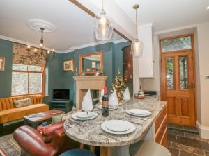 a living room with a table and a couch at Losehill View in Castleton