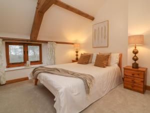 a bedroom with a large white bed and a window at Varley Lodge in Barnstaple