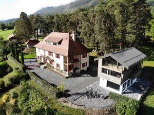 an aerial view of a house in the mountains at Les Ô d'Annecy in Saint-Jorioz