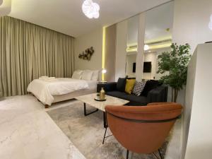 a hotel room with a bed and a couch at Bahrain bay studio in Manama