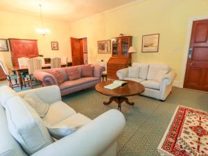 a living room with couches and a table at Braeriach - Mar Lodge Estate in Ballater
