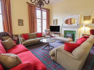 a living room with couches and a fireplace at Bynack - Mar Lodge Estate in Ballater