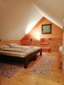 a bedroom with a bed and a rug at Apartment Nikitovic in Žabljak