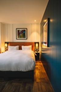 a bedroom with a large white bed and two lamps at The Dean Cork in Cork
