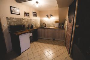a kitchen with a counter and a sink and a refrigerator at APPART Centre HISTORIQUE CHEZ RENÉ wifi in Troyes