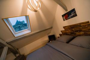 a bedroom with a bed and a picture of a castle at APPART Centre HISTORIQUE CHEZ RENÉ wifi in Troyes